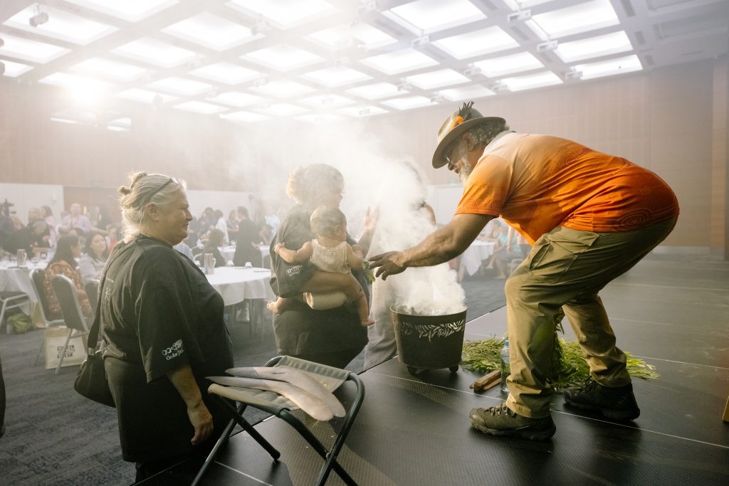 Noel Nannup conducting a smoking ceremony at a event