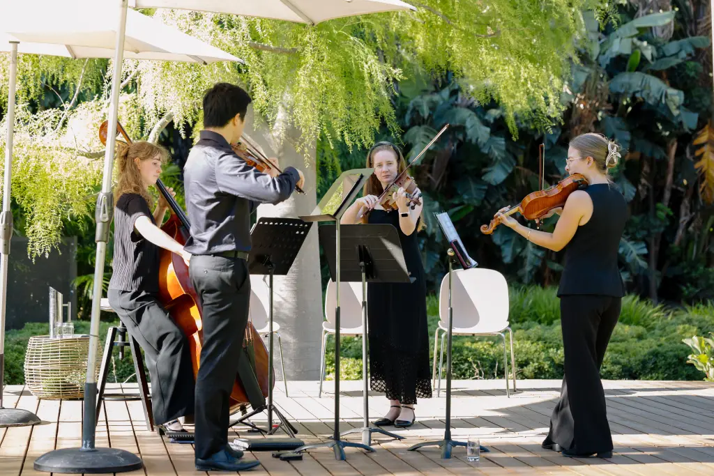 a small musician group playing at the event